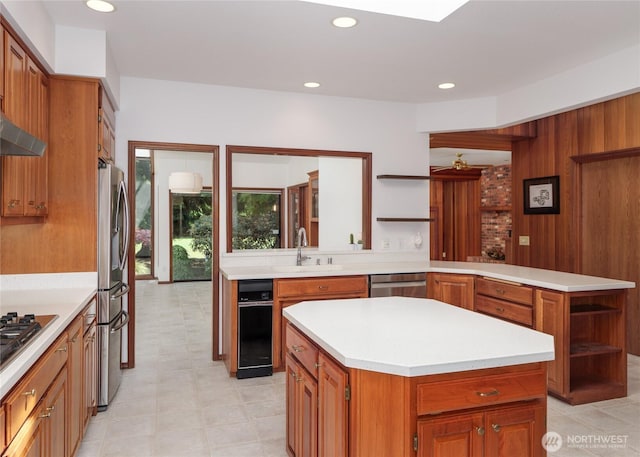 125 Arnold Palmer Pkwy, Sequim, WA 98382 - kitchen with open shelves, appliances with stainless steel finishes, a peninsula, light countertops, and a center island