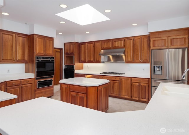 125 Arnold Palmer Pkwy, Sequim, WA 98382 - kitchen featuring oven, stainless steel fridge with ice dispenser, a warming drawer, a skylight, and gas cooktop