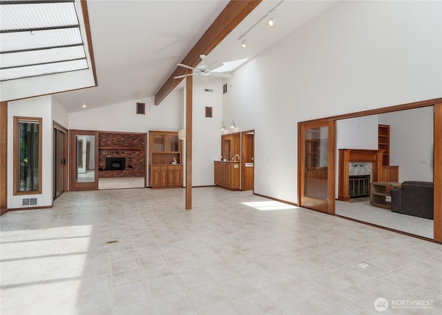 125 Arnold Palmer Pkwy, Sequim, WA 98382 - unfurnished living room featuring a fireplace, a ceiling fan, high vaulted ceiling, and beamed ceiling