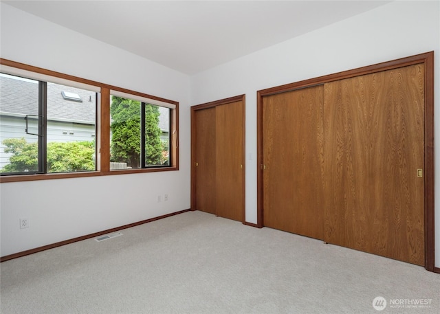 125 Arnold Palmer Pkwy, Sequim, WA 98382 - unfurnished bedroom featuring multiple closets and carpet floors