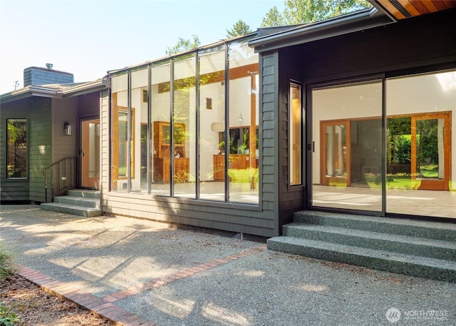 125 Arnold Palmer Pkwy, Sequim, WA 98382 - property entrance featuring a chimney and a patio area