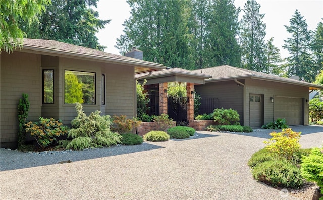 125 Arnold Palmer Pkwy, Sequim, WA 98382 - view of front facade featuring driveway, a chimney, and a garage