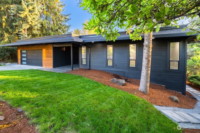 view of front of house with a garage and a front lawn