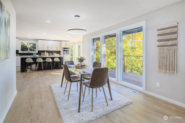 dining space featuring light wood-type flooring