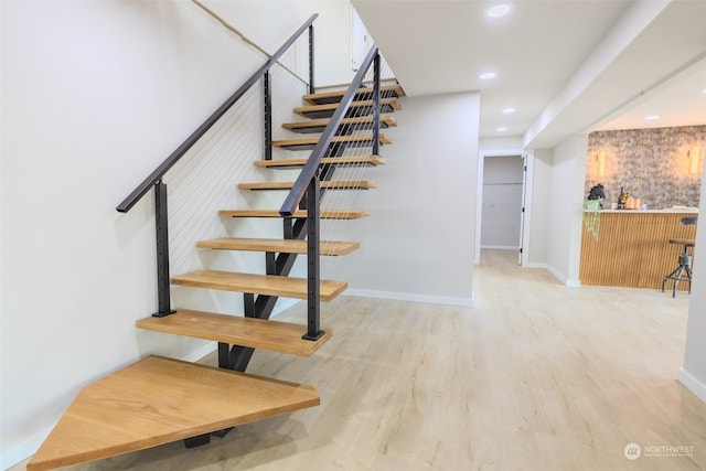 staircase featuring wood-type flooring