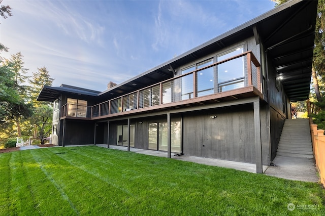 rear view of house featuring a yard