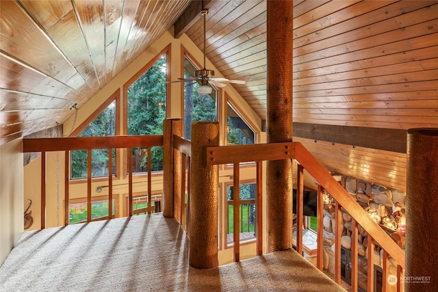 interior space featuring wooden ceiling, lofted ceiling with beams, and a ceiling fan