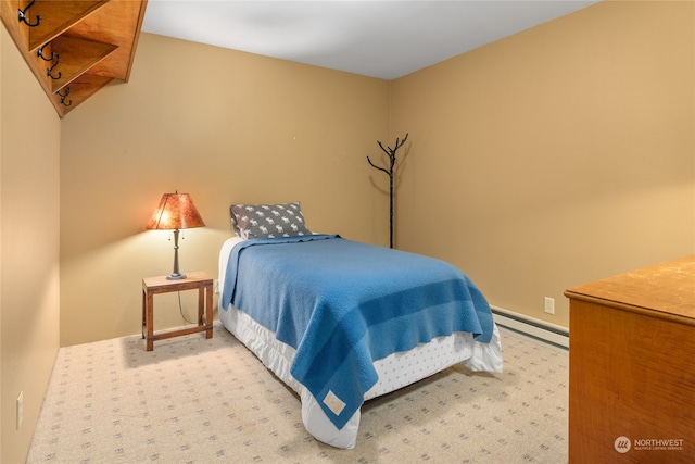 carpeted bedroom featuring a baseboard heating unit