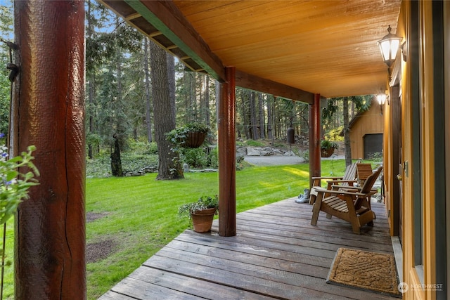 wooden deck featuring a yard