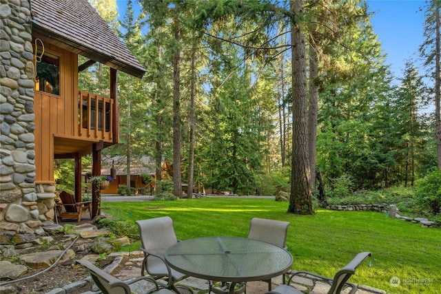 view of yard with outdoor dining space and a patio