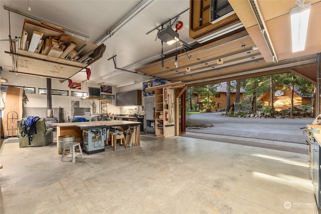 garage with a garage door opener and a workshop area