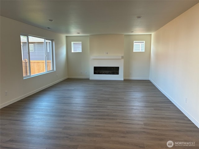 12707 172nd Avenue Ct E Unit 135, Bonney Lake, WA 98391 - unfurnished living room with a fireplace, dark wood-style flooring, and baseboards