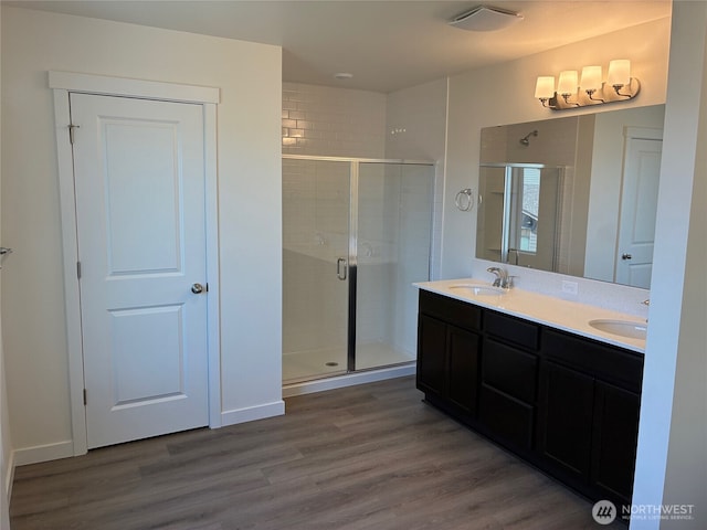 12707 172nd Avenue Ct E Unit 135, Bonney Lake, WA 98391 - full bath with a shower stall, wood finished floors, and double vanity