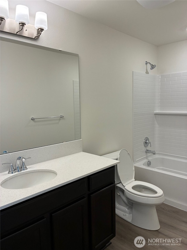 12707 172nd Avenue Ct E Unit 135, Bonney Lake, WA 98391 - bathroom with toilet, wood finished floors, vanity, and shower / washtub combination