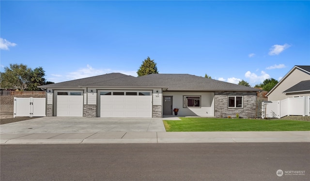 view of front of home featuring a front yard and a garage