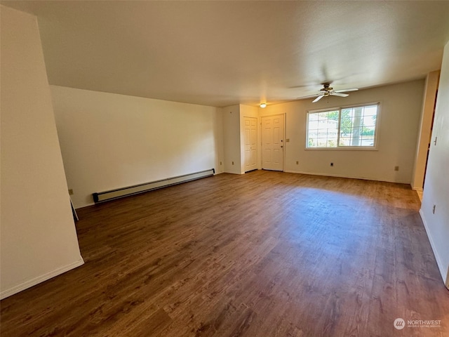 interior space with a baseboard heating unit, ceiling fan, and dark hardwood / wood-style flooring