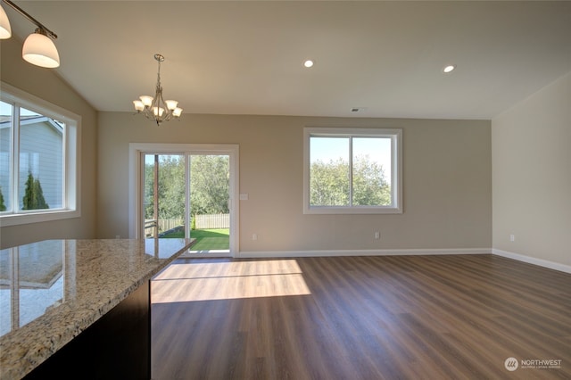 interior space with dark wood-type flooring, a chandelier, and a healthy amount of sunlight