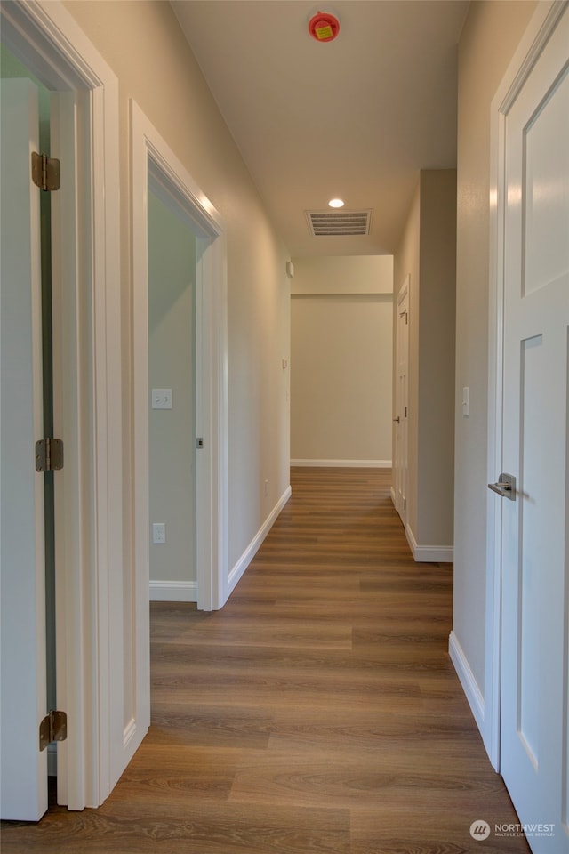 corridor with light hardwood / wood-style floors