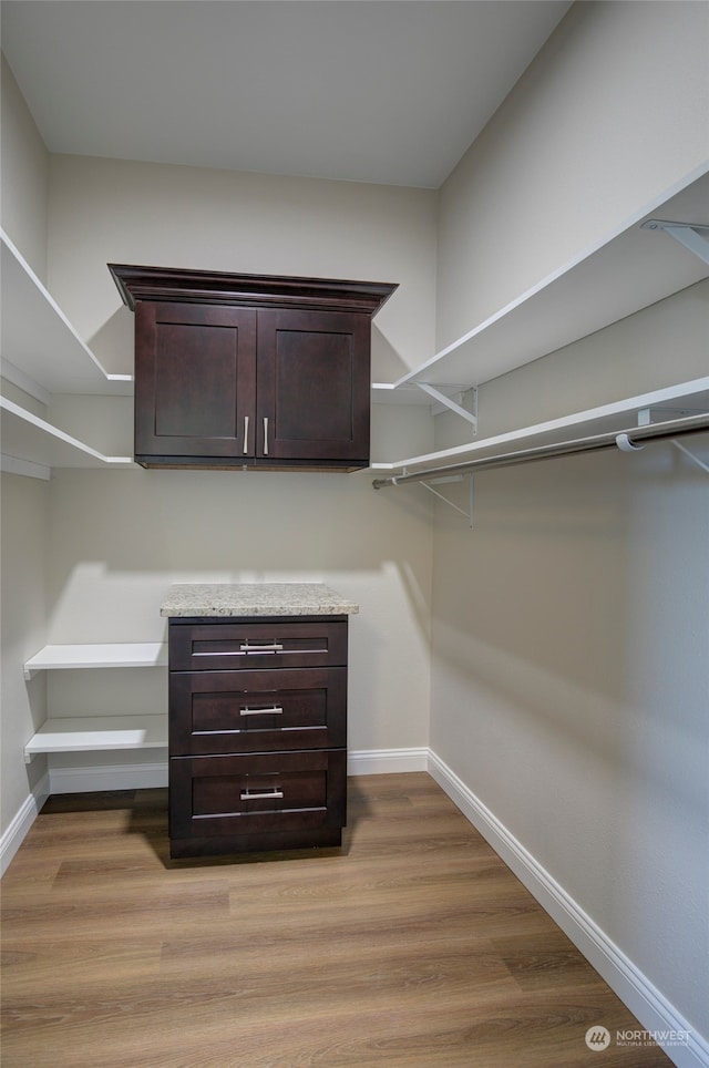 spacious closet featuring light hardwood / wood-style flooring