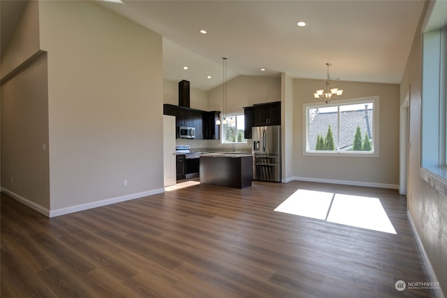 kitchen featuring a kitchen island, dark hardwood / wood-style floors, vaulted ceiling, and stainless steel appliances