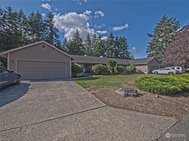 ranch-style house featuring a garage and a front lawn