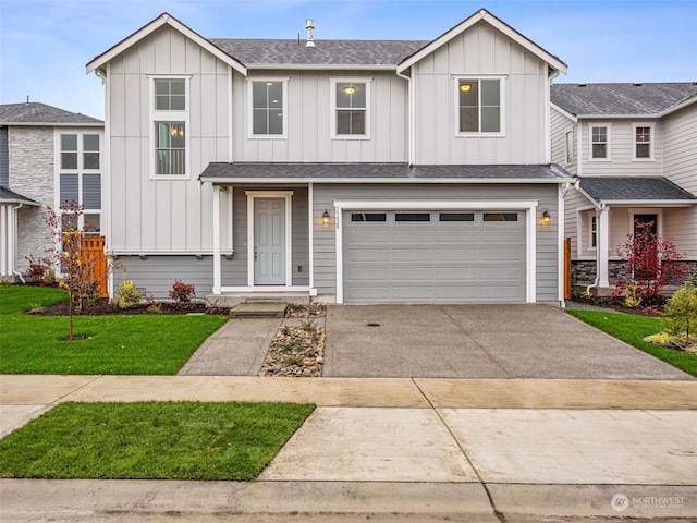 view of front of house featuring a front lawn and a garage