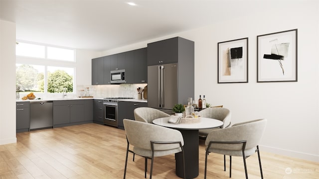 dining space featuring light hardwood / wood-style floors and sink