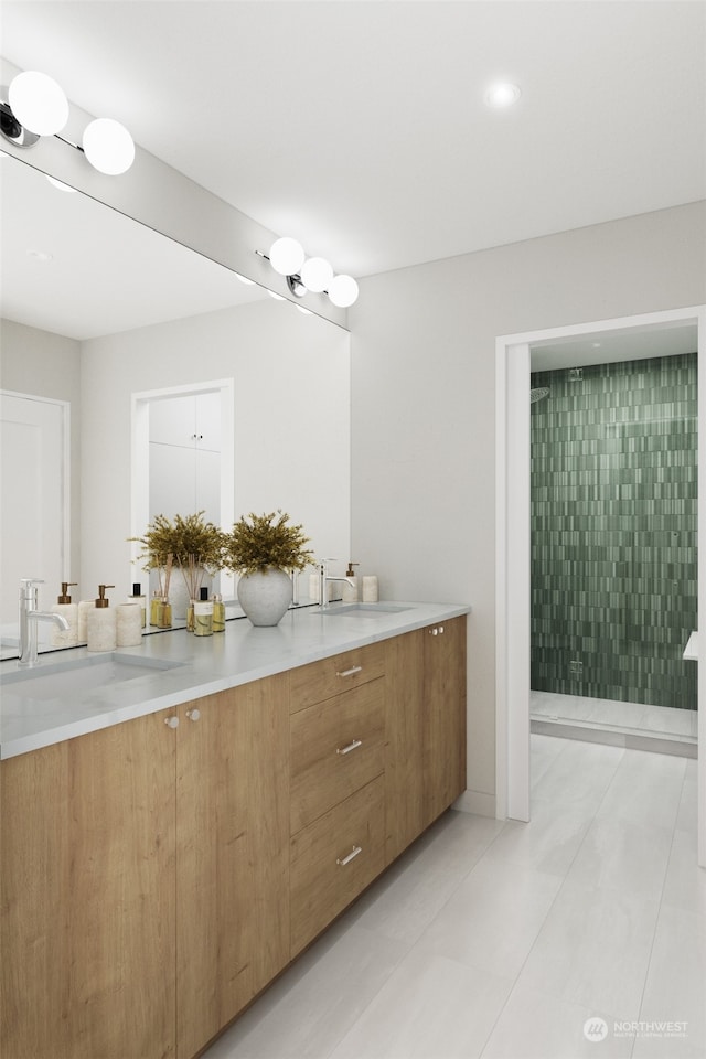 bathroom with tile patterned flooring, vanity, and tiled shower