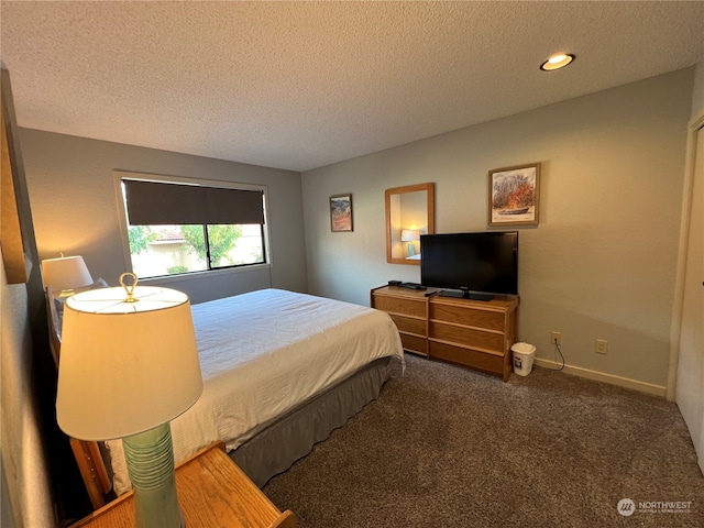 carpeted bedroom with a textured ceiling