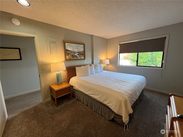 carpeted bedroom with a textured ceiling