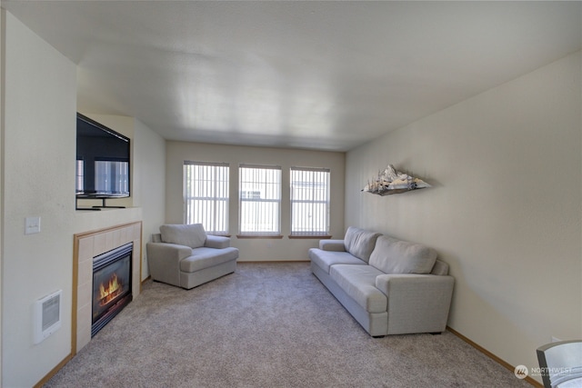 carpeted living room with a fireplace