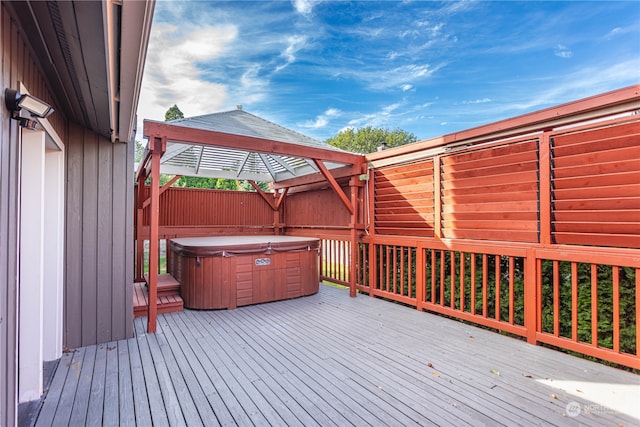 wooden terrace featuring a hot tub