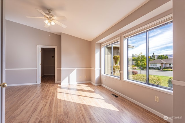 spare room with light hardwood / wood-style floors, lofted ceiling, and ceiling fan