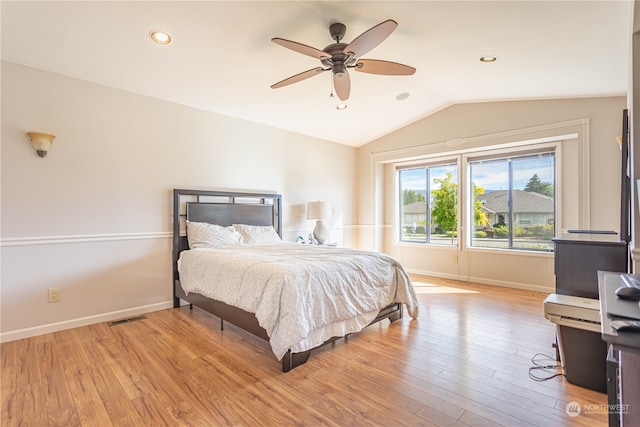 bedroom featuring vaulted ceiling, light wood-type flooring, and ceiling fan