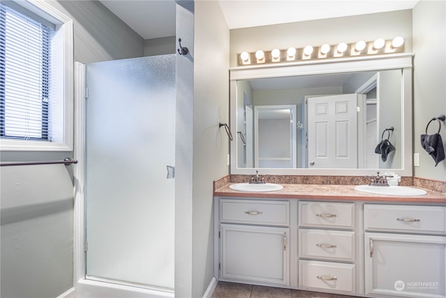 bathroom with vanity, a shower with shower door, and tile patterned flooring