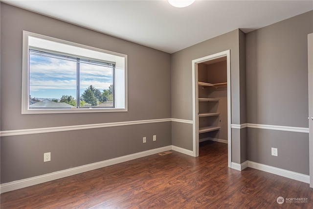 unfurnished room with dark hardwood / wood-style floors