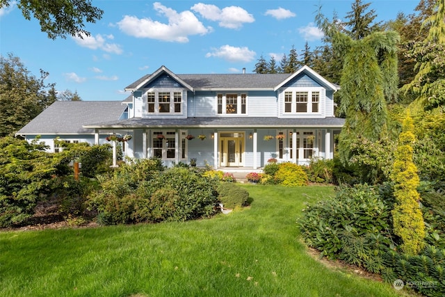 view of front of property featuring covered porch and a front yard