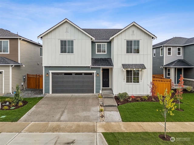 view of front of home featuring a front yard and a garage