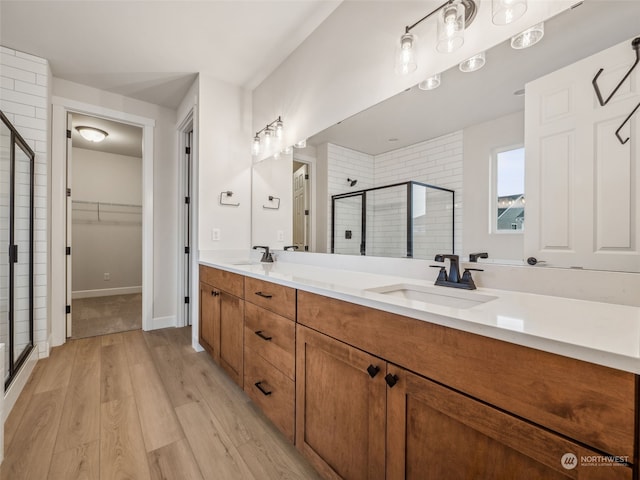 bathroom featuring vanity, wood-type flooring, and an enclosed shower