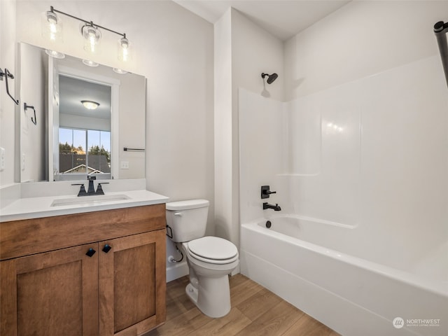 full bathroom with vanity, tub / shower combination, wood-type flooring, and toilet