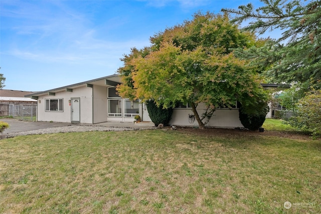 rear view of property with a yard