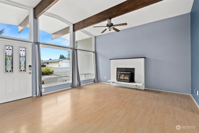 unfurnished living room with light wood-type flooring, ceiling fan, and beamed ceiling