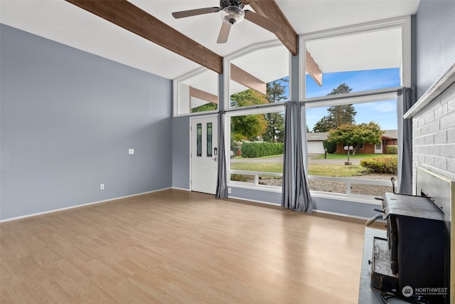 unfurnished living room with light wood-type flooring, vaulted ceiling with beams, and ceiling fan