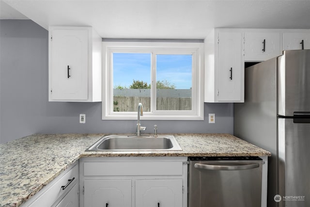 kitchen featuring white cabinetry, sink, and stainless steel appliances