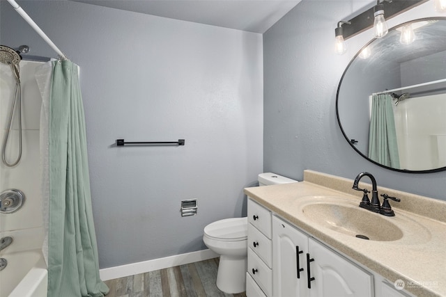 full bathroom with vanity, toilet, shower / bath combo with shower curtain, and hardwood / wood-style flooring