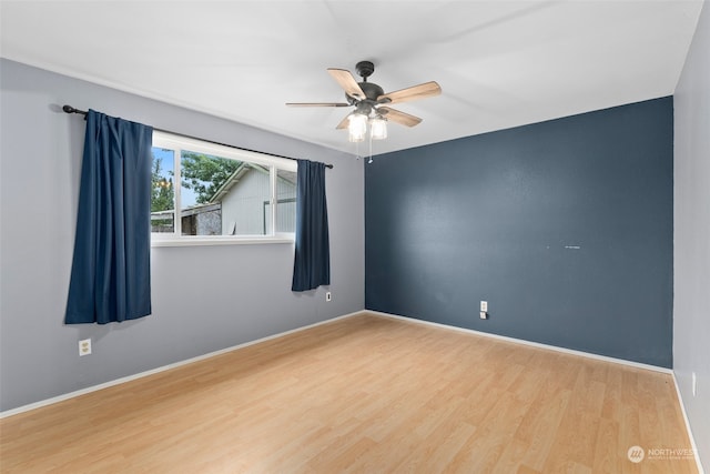 empty room featuring ceiling fan and hardwood / wood-style floors