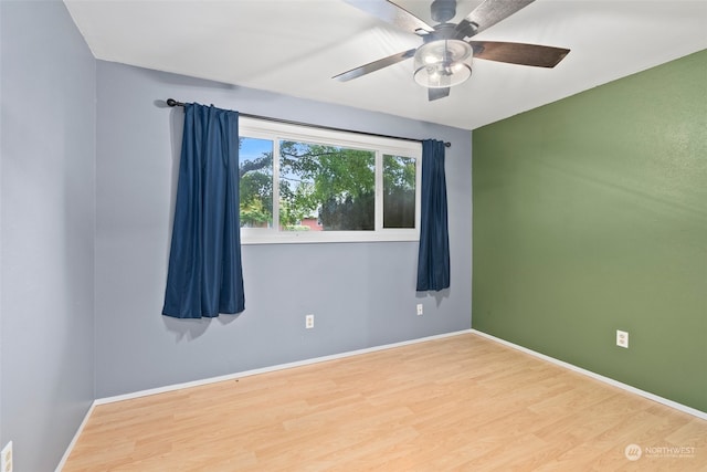 spare room with hardwood / wood-style floors and ceiling fan