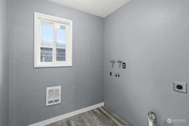 clothes washing area featuring hookup for a washing machine, hardwood / wood-style floors, and hookup for an electric dryer