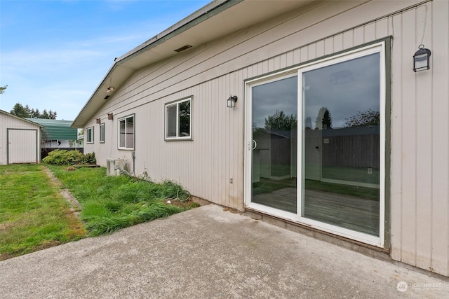 view of home's exterior with a lawn, a patio area, and central air condition unit