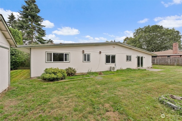 back of property featuring a yard and ac unit